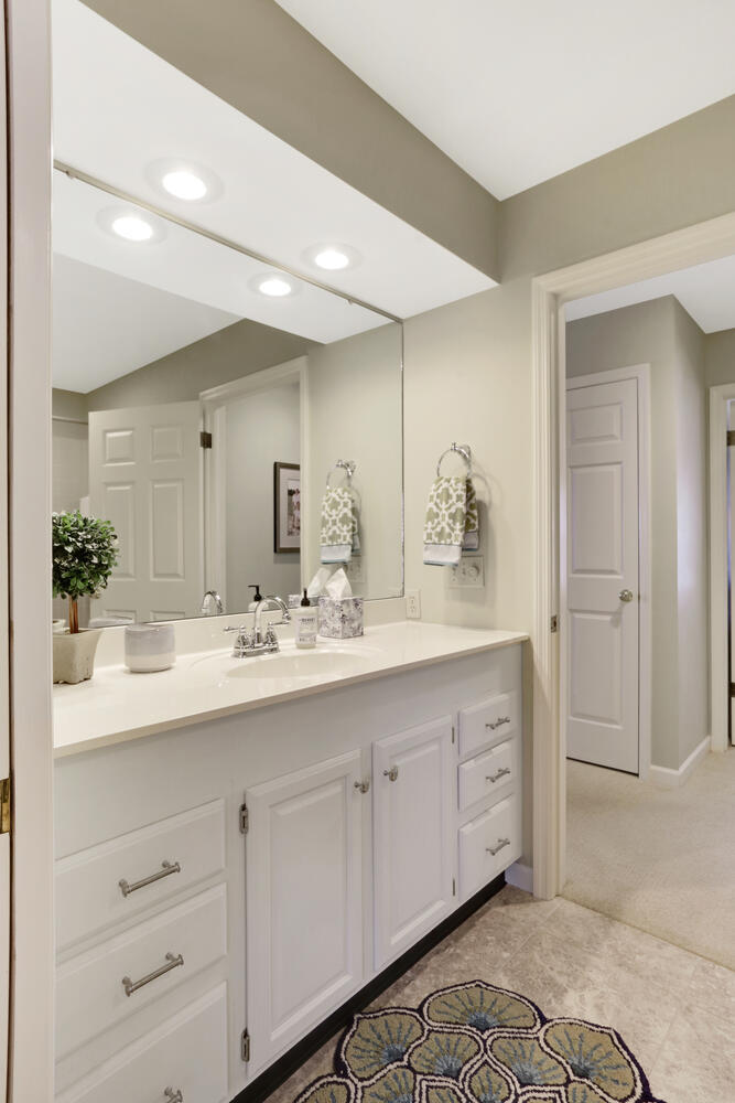 1727 Lakeside Drive, Unit B Champaign, IL 61821 - Photo 24 of 35 a bathroom with a double vanity sink and a mirror