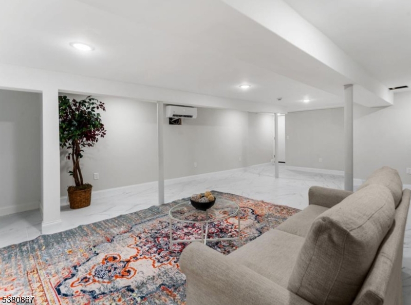 321 William Street, Unit 1 Harrison, NJ 07029 - Photo 12 of 15 a living room with furniture and a potted plant