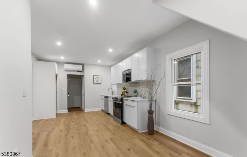 321 William Street, Unit 1 Harrison, NJ 07029 - Photo 5 of 15 a view of kitchen with stainless steel appliances granite countertop a refrigerator and a stove top oven