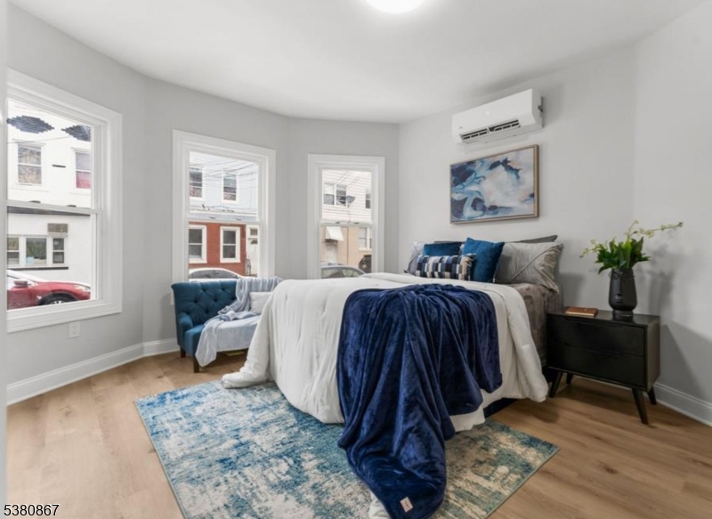 321 William Street, Unit 1 Harrison, NJ 07029 - Photo 6 of 15 a bedroom with bed and wooden floor