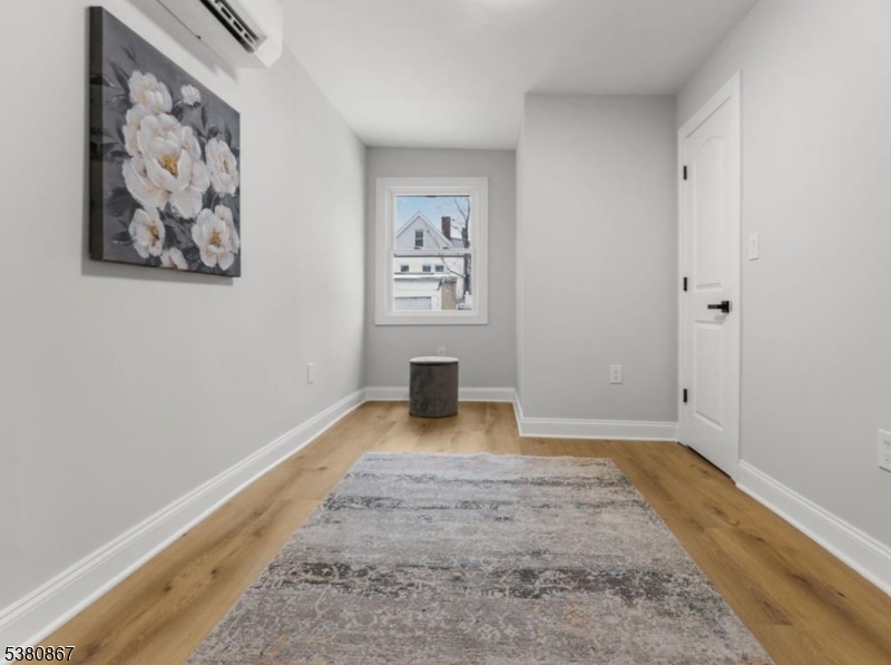 321 William Street, Unit 1 Harrison, NJ 07029 - Photo 8 of 15 a view of a hallway with wooden floor
