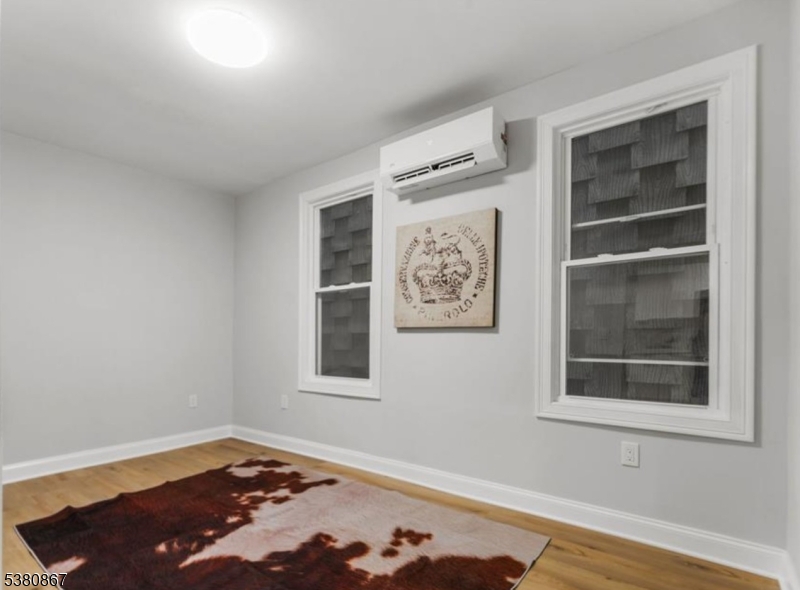 321 William Street, Unit 1 Harrison, NJ 07029 - Photo 10 of 15 a bedroom with a bed and a window