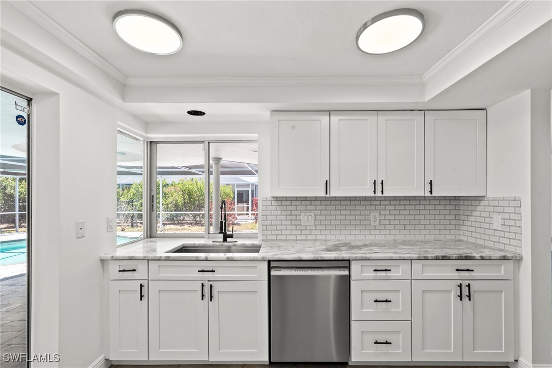 12331 McGregor Boulevard Fort Myers, FL 33919 - Photo 13 of 46 a kitchen with granite countertop a sink white cabinets and a window