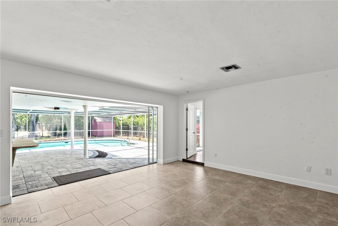 12331 McGregor Boulevard Fort Myers, FL 33919 - Photo 17 of 46 an empty room with wooden floor and windows