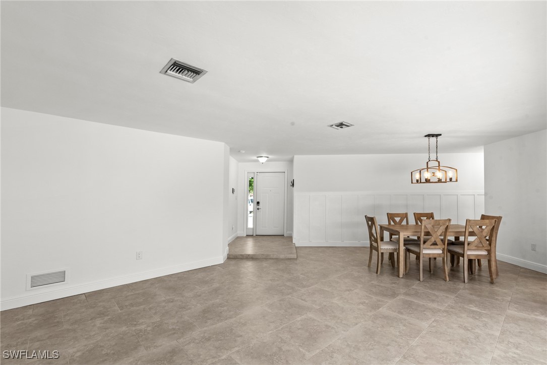 12331 McGregor Boulevard Fort Myers, FL 33919 - Photo 19 of 46 a view of a dining room with furniture and chandelier