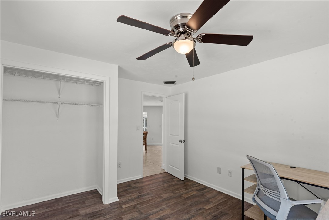 12331 McGregor Boulevard Fort Myers, FL 33919 - Photo 27 of 46 a view of a hallway with wooden floor and a ceiling fan