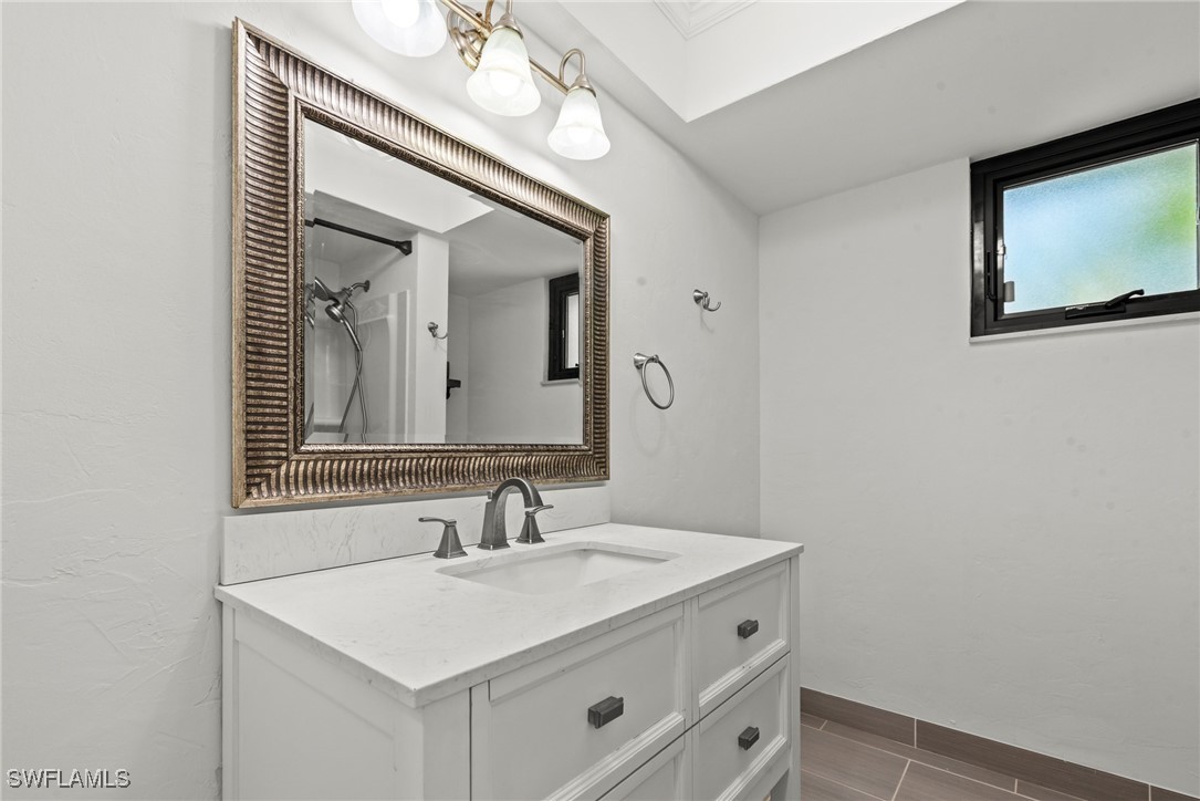 12331 McGregor Boulevard Fort Myers, FL 33919 - Photo 30 of 46 a bathroom with a sink vanity and a mirror