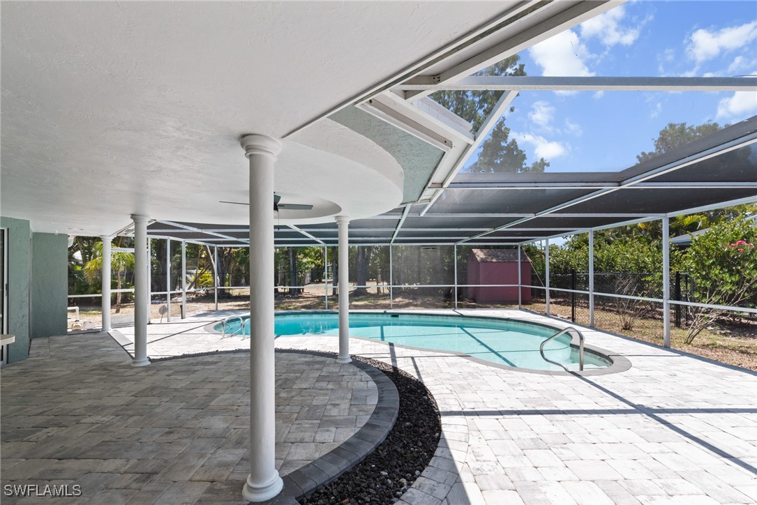 12331 McGregor Boulevard Fort Myers, FL 33919 - Photo 32 of 46 a view of a swimming pool with a patio and a yard