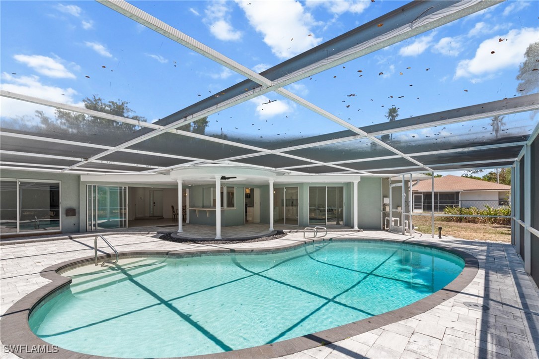 12331 McGregor Boulevard Fort Myers, FL 33919 - Photo 34 of 46 a swimming pool with chairs and tables