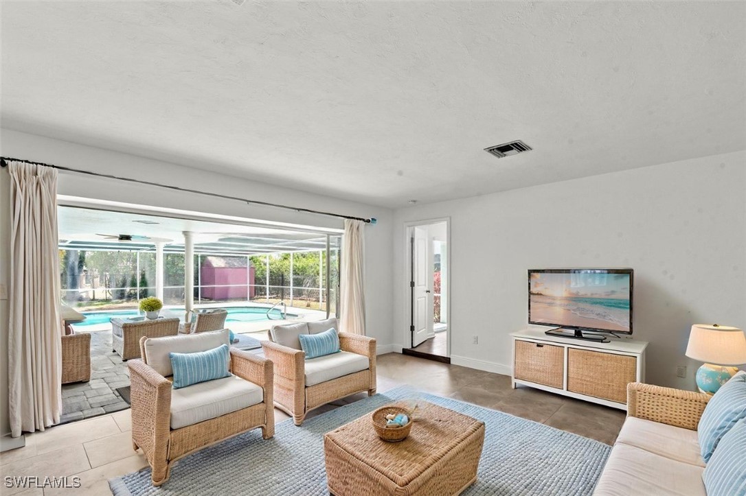 12331 McGregor Boulevard Fort Myers, FL 33919 - Photo 4 of 46 a living room with furniture and a flat screen tv