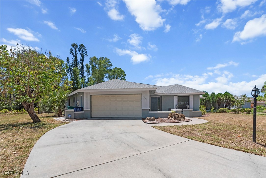 12331 McGregor Boulevard Fort Myers, FL 33919 - Photo 42 of 46 a front view of a house with a yard and trees