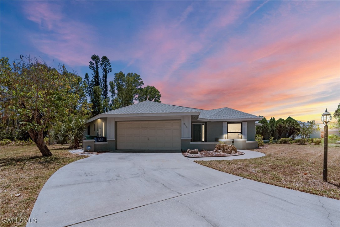 12331 McGregor Boulevard Fort Myers, FL 33919 - Photo 43 of 46 a front view of a house with a yard and trees