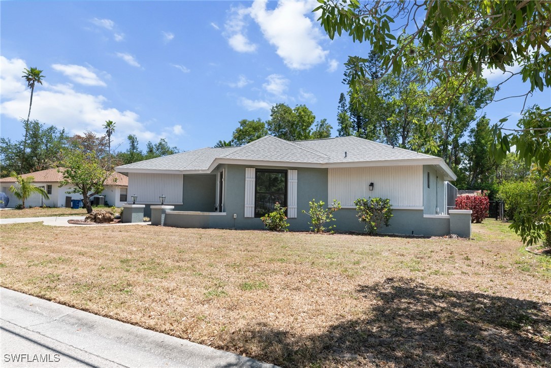12331 McGregor Boulevard Fort Myers, FL 33919 - Photo 46 of 46 a front view of a house with a yard and garage