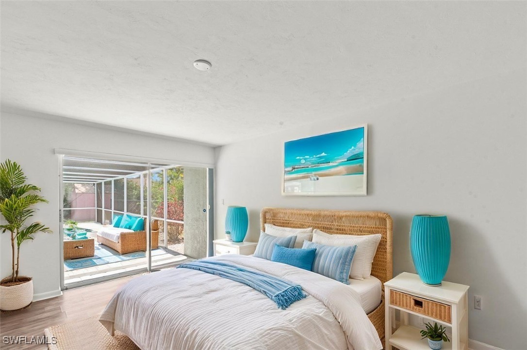 12331 McGregor Boulevard Fort Myers, FL 33919 - Photo 5 of 46 a bedroom with a balcony a bed and a couch