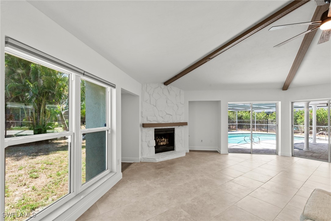 12331 McGregor Boulevard Fort Myers, FL 33919 - Photo 7 of 46 wooden floor fireplace and windows in an empty room