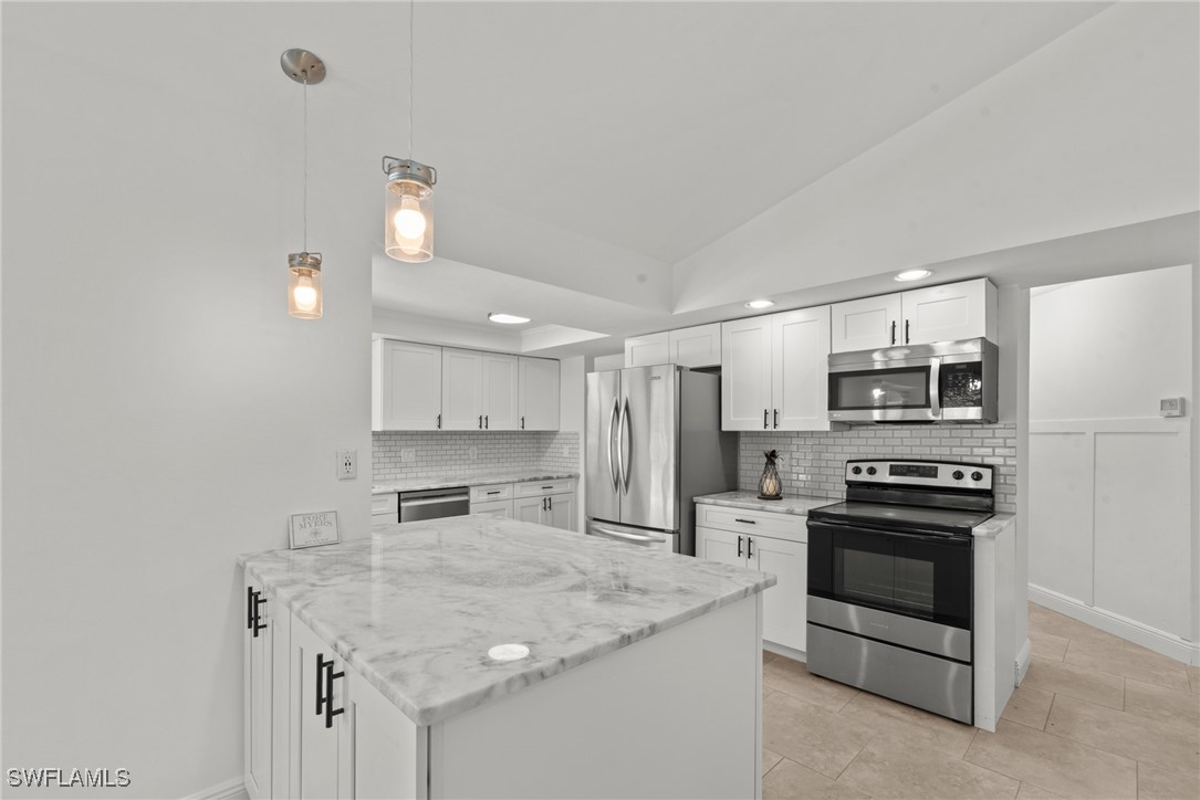 12331 McGregor Boulevard Fort Myers, FL 33919 - Photo 9 of 46 a kitchen with stainless steel appliances granite countertop a sink stove oven and refrigerator