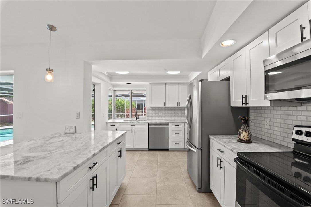 12331 McGregor Boulevard Fort Myers, FL 33919 - Photo 10 of 46 a kitchen with a sink stove and refrigerator