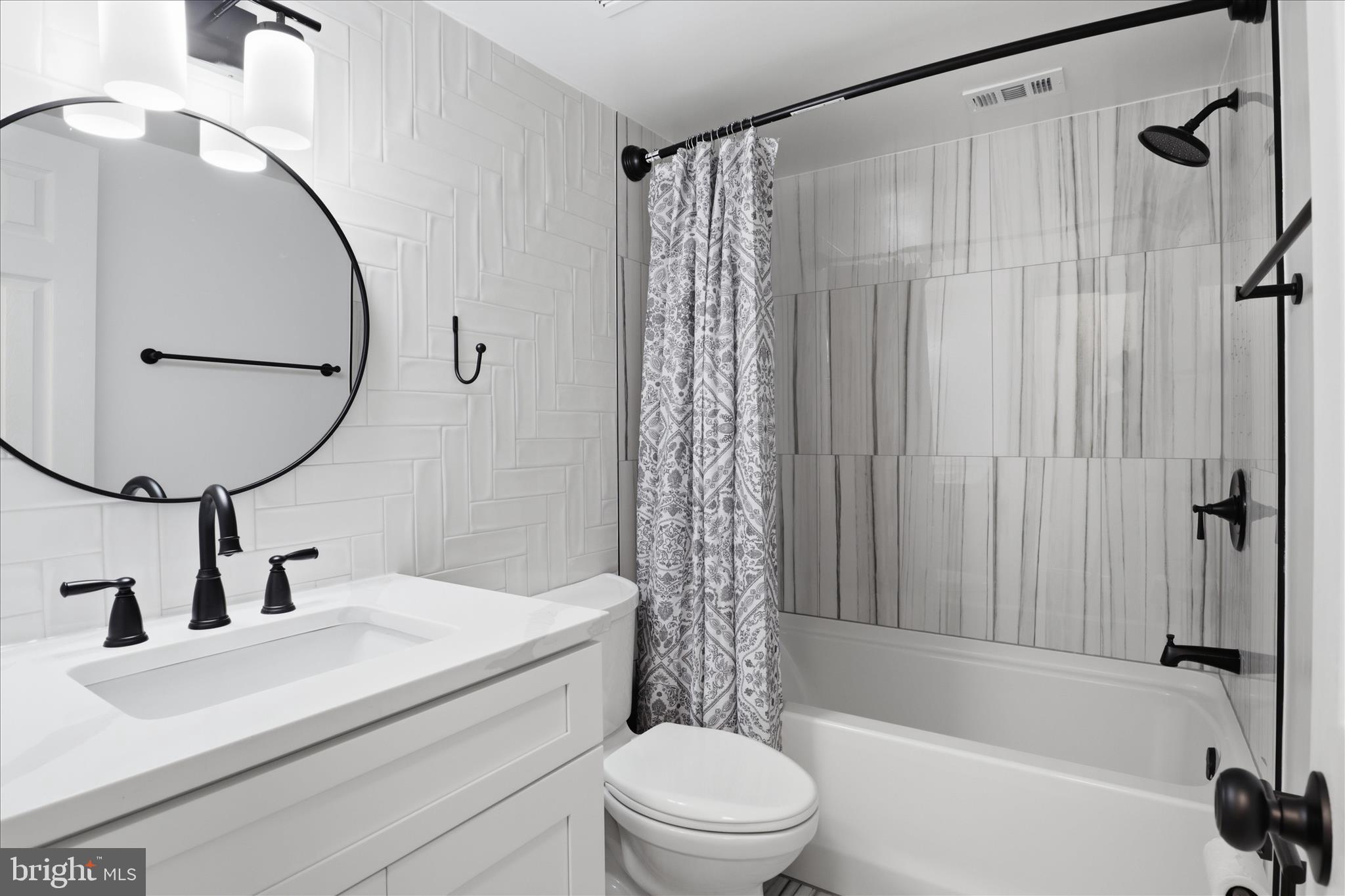 8300 Tobin Road, Unit 23 Annandale, VA 22003 - Photo 17 of 37 a bathroom with a sink a toilet and a mirror