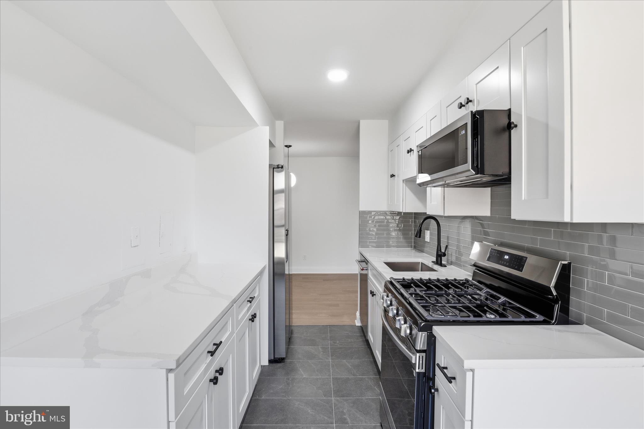 8300 Tobin Road, Unit 23 Annandale, VA 22003 - Photo 23 of 37 a kitchen with stainless steel appliances granite countertop a stove and a sink