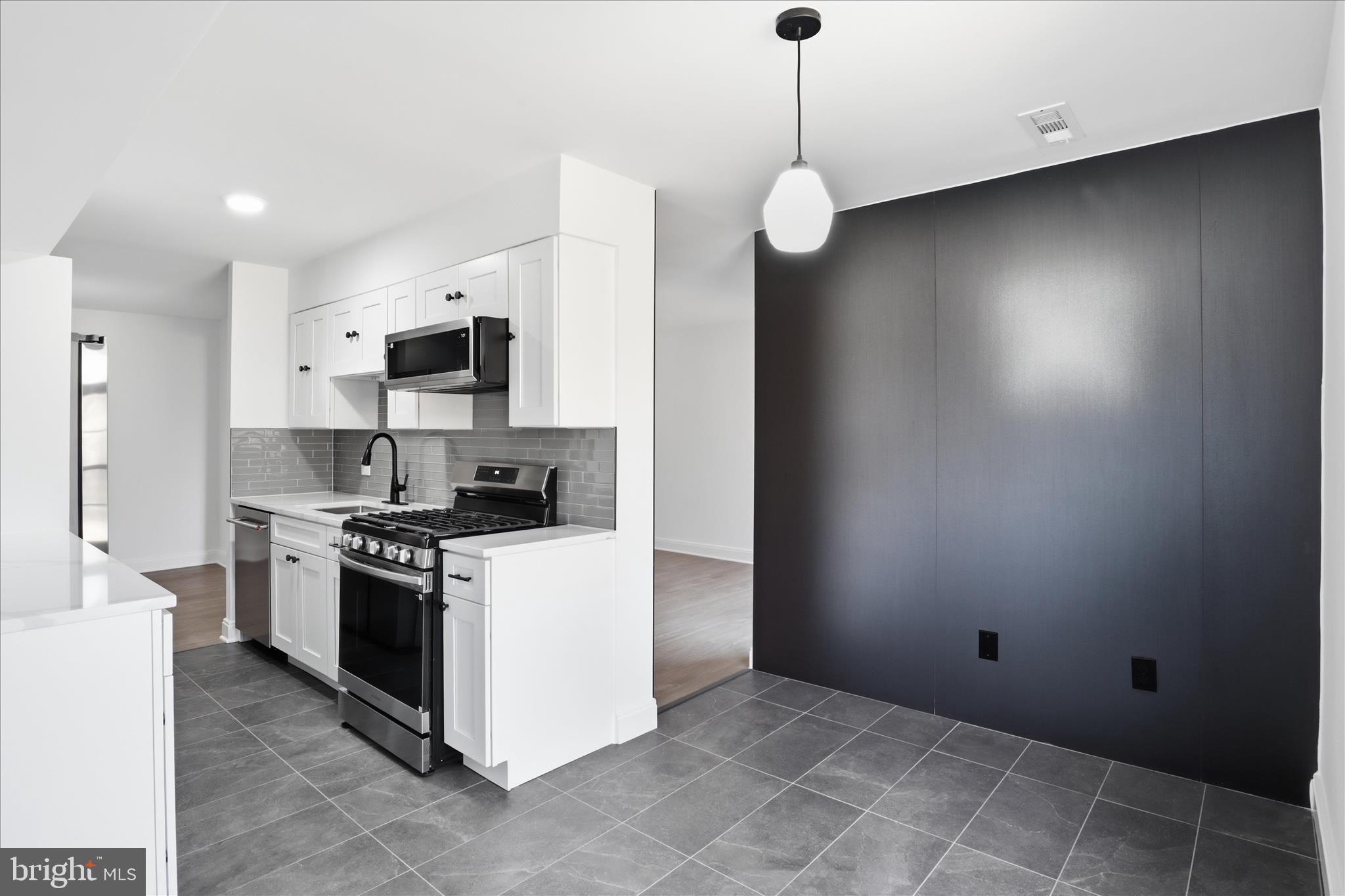 8300 Tobin Road, Unit 23 Annandale, VA 22003 - Photo 5 of 37 a kitchen with stainless steel appliances a stove a microwave and a refrigerator