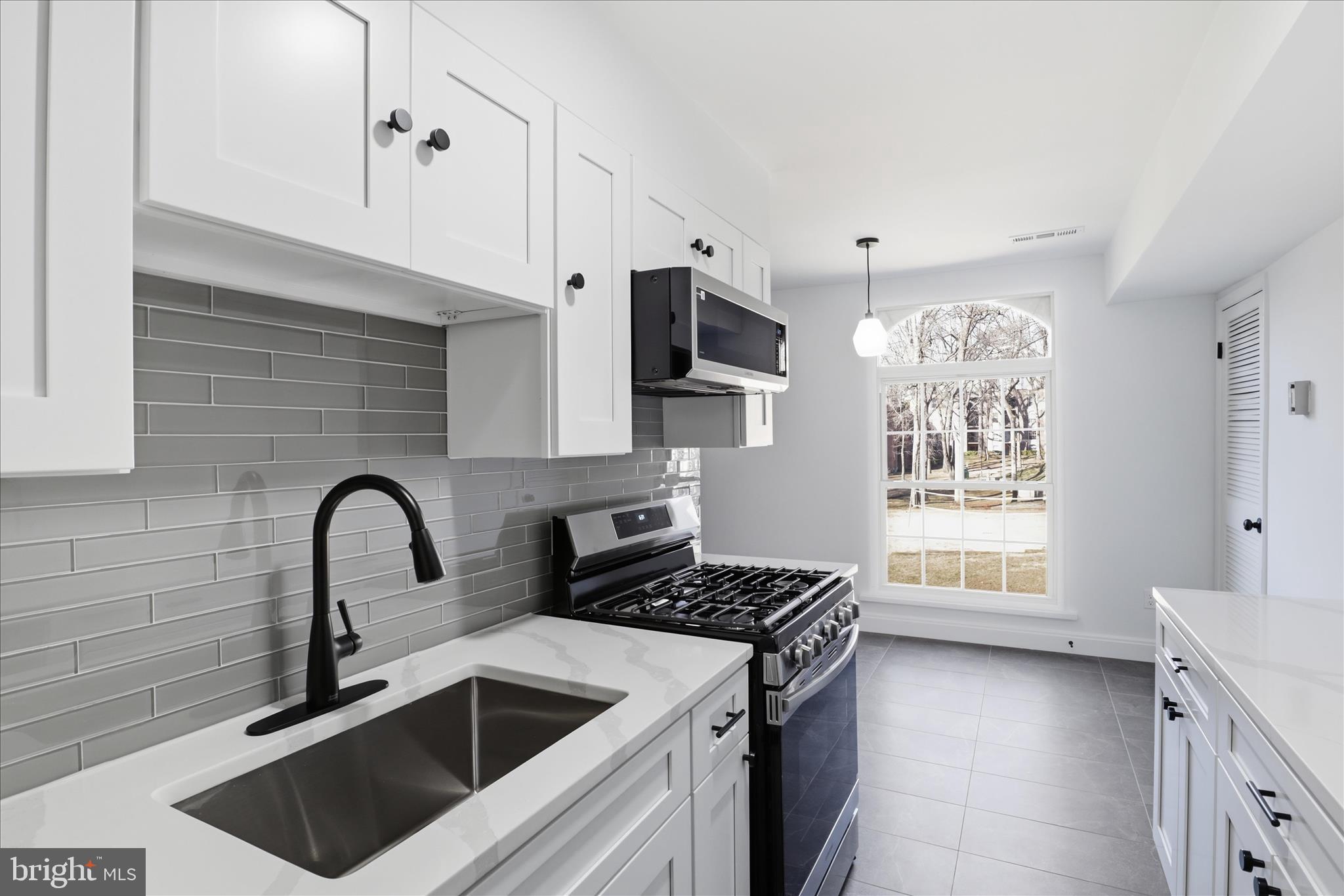 8300 Tobin Road, Unit 23 Annandale, VA 22003 - Photo 8 of 37 a kitchen with granite countertop a sink a stove and cabinets