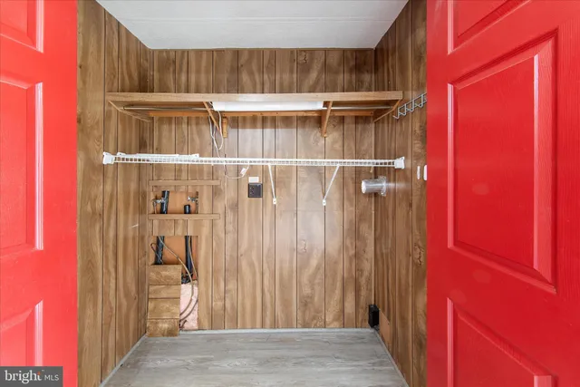 a bedroom with a bed a chandelier and a mirror on dresser