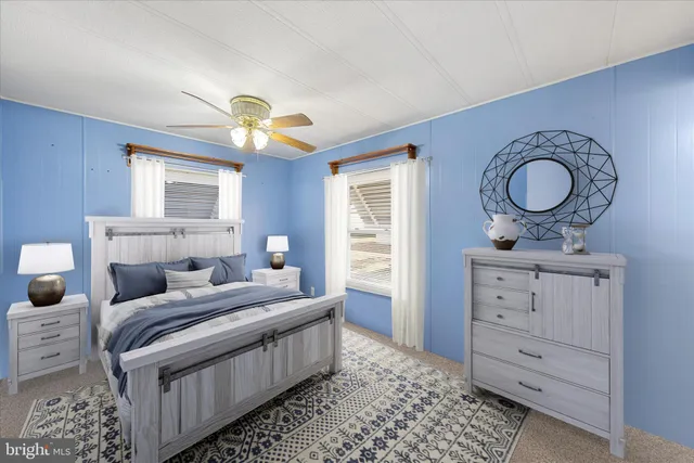 a view of an empty room with window and chandelier fan