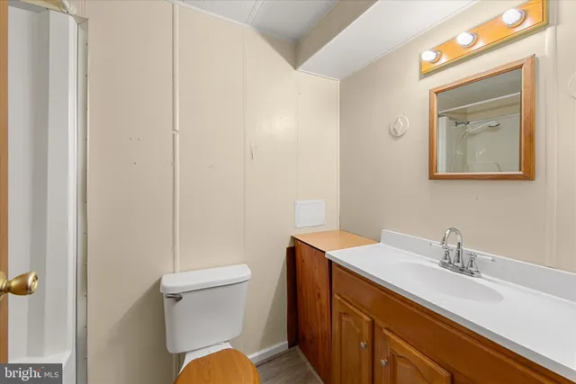 a white toilet sitting next to a bath tub
