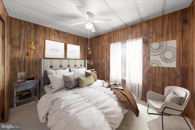 a living room with a bed and a chandelier