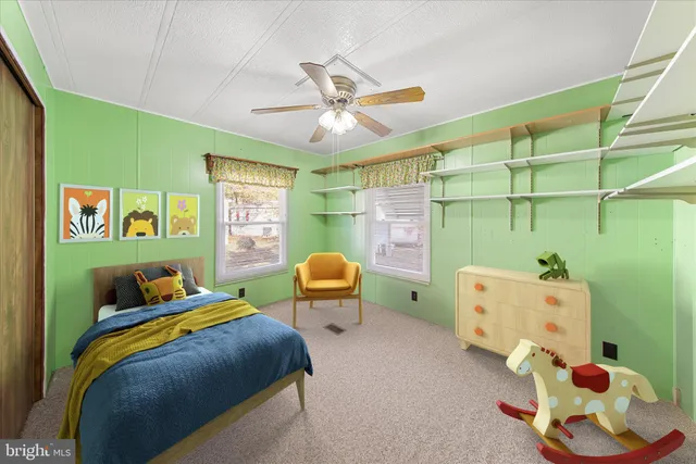 a view of a room with a chandelier fan