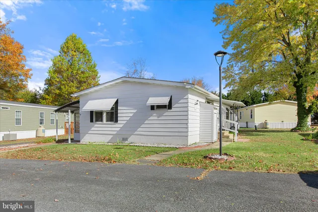 a front view of a house with a garden and yard