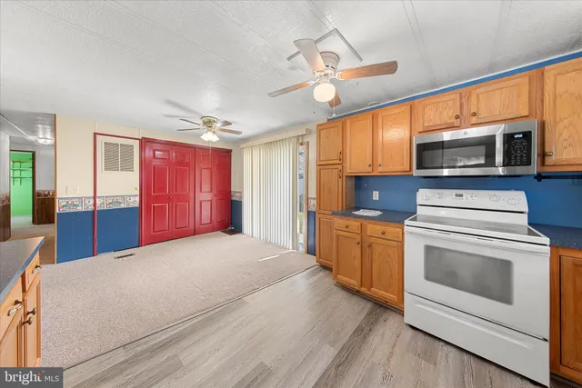 a kitchen with stove cabinets and stainless steel appliances