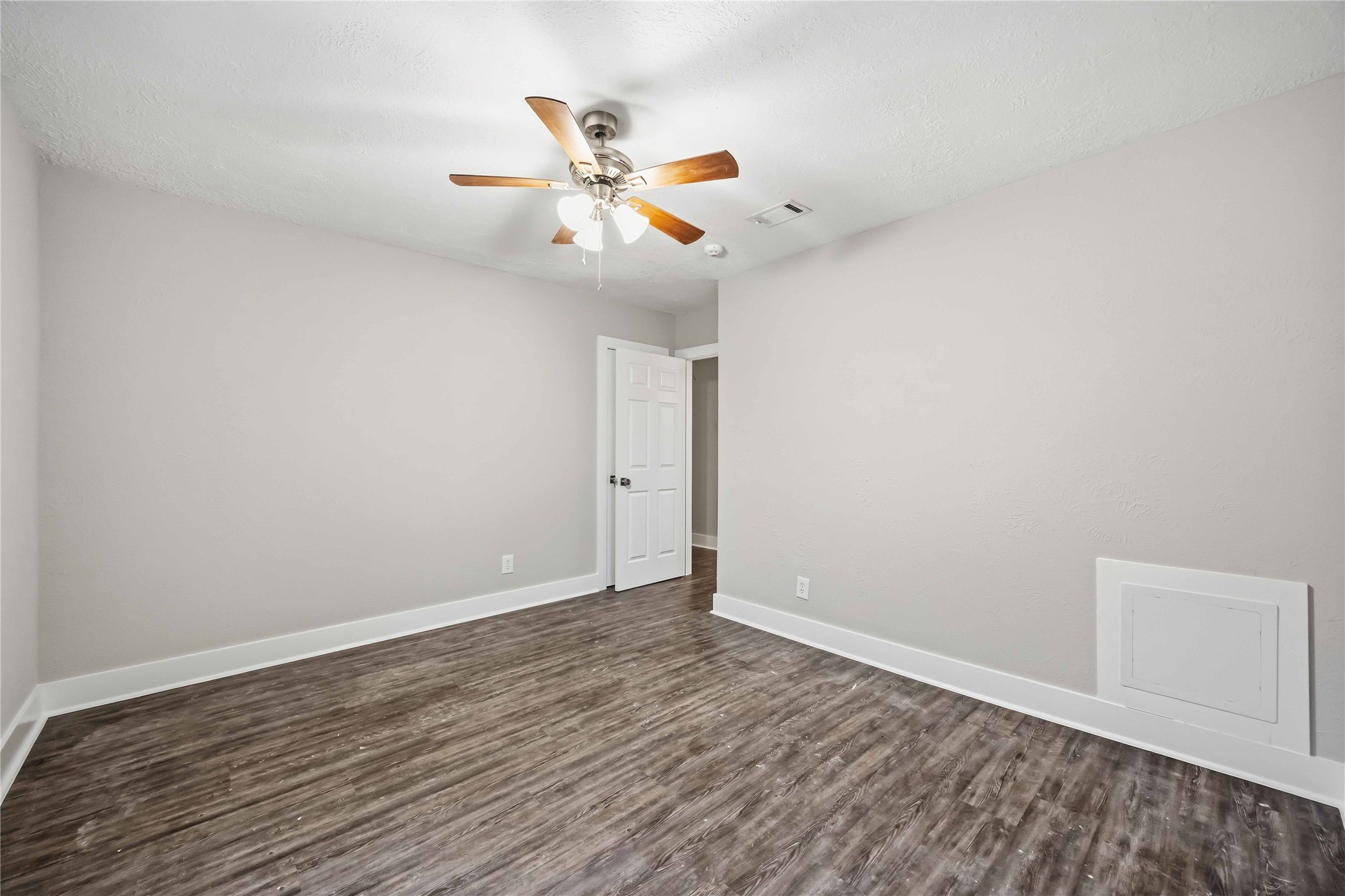 113 East Witcher Lane Houston, TX 77076 - Photo 18 of 21 an empty room with wooden floor fan and windows
