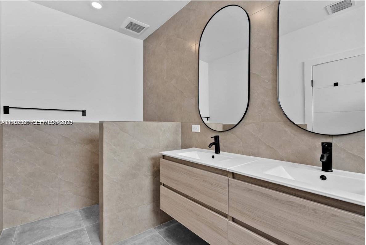 2737 Southwest 2nd Street, Unit 1 Miami, FL 33135 - Photo 14 of 25 a bathroom with a sink and a mirror