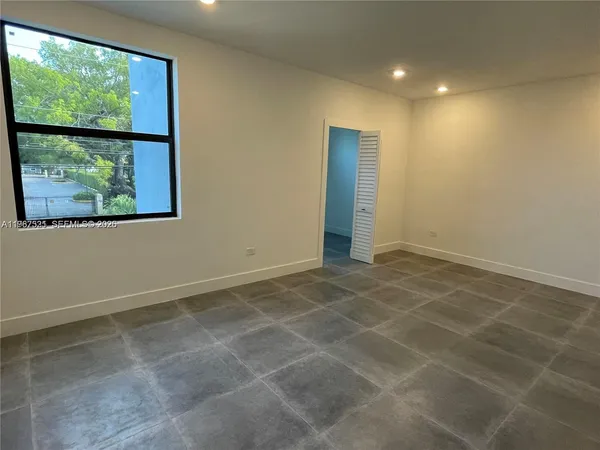 a view of an empty room with a window