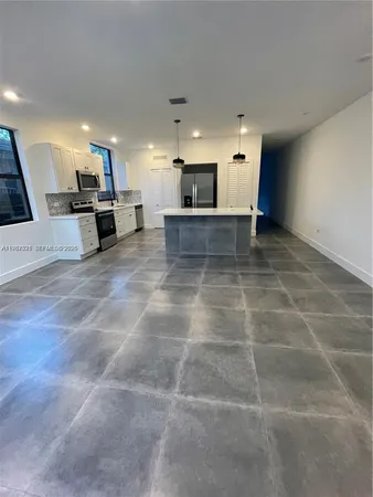 a view of a living room with kitchen