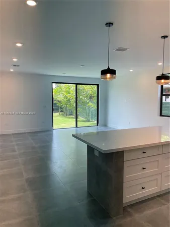 a kitchen with a table and window