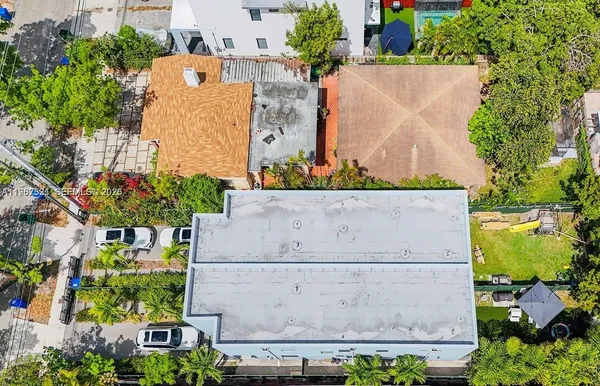 an aerial view of a house with a garden and swimming pool