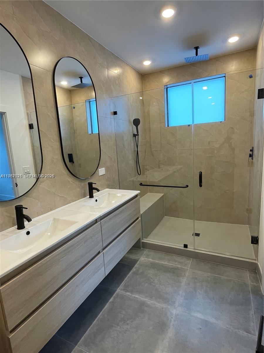 2737 Southwest 2nd Street, Unit 1 Miami, FL 33135 - Photo 10 of 25 a bathroom with a double vanity sink and a mirror