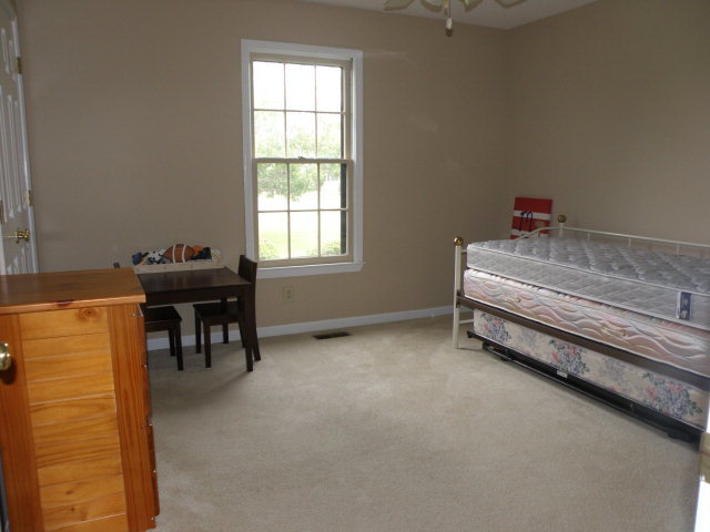 210 J R Boulevard Macon, GA 31220 - Photo 13 of 19 a bedroom with a bed and a desk