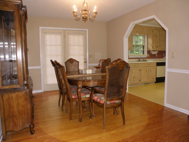 210 J R Boulevard Macon, GA 31220 - Photo 4 of 19 a dining room with furniture a chandelier and wooden floor