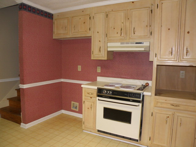 210 J R Boulevard Macon, GA 31220 - Photo 5 of 19 a kitchen with granite countertop white cabinets and stainless steel appliances