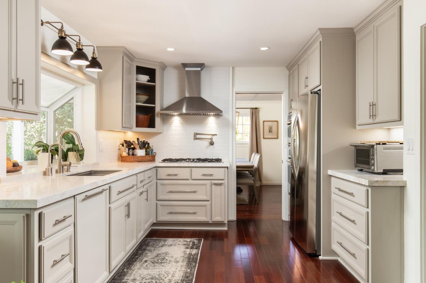 2 Black Tail Lane Monterey, CA 93940 - Photo 11 of 32 a kitchen with white cabinets and stainless steel appliances