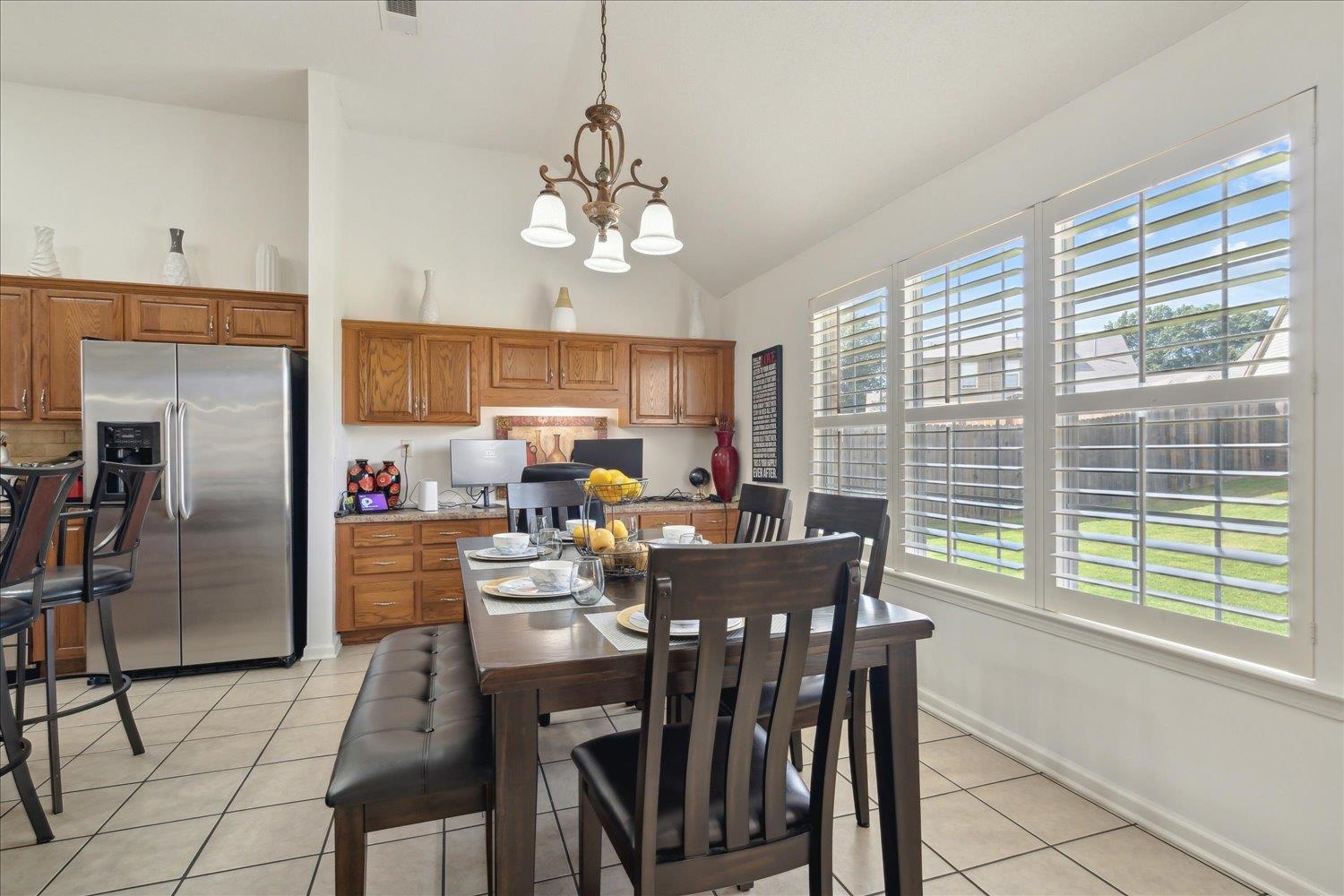 7464 Britt Way Memphis, TN 38125 - Photo 12 of 29 a view of a dining room with furniture a chandelier and window