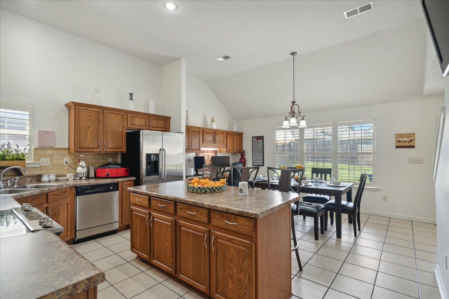 7464 Britt Way Memphis, TN 38125 - Photo 18 of 29 a kitchen with sink a stove and chairs