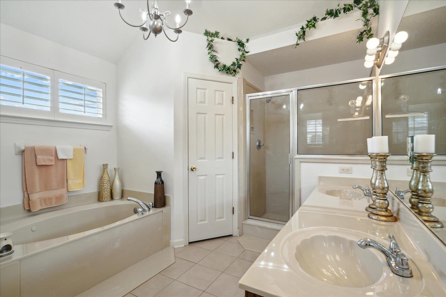 7464 Britt Way Memphis, TN 38125 - Photo 20 of 29 a bathroom with a sink a tub and a mirror