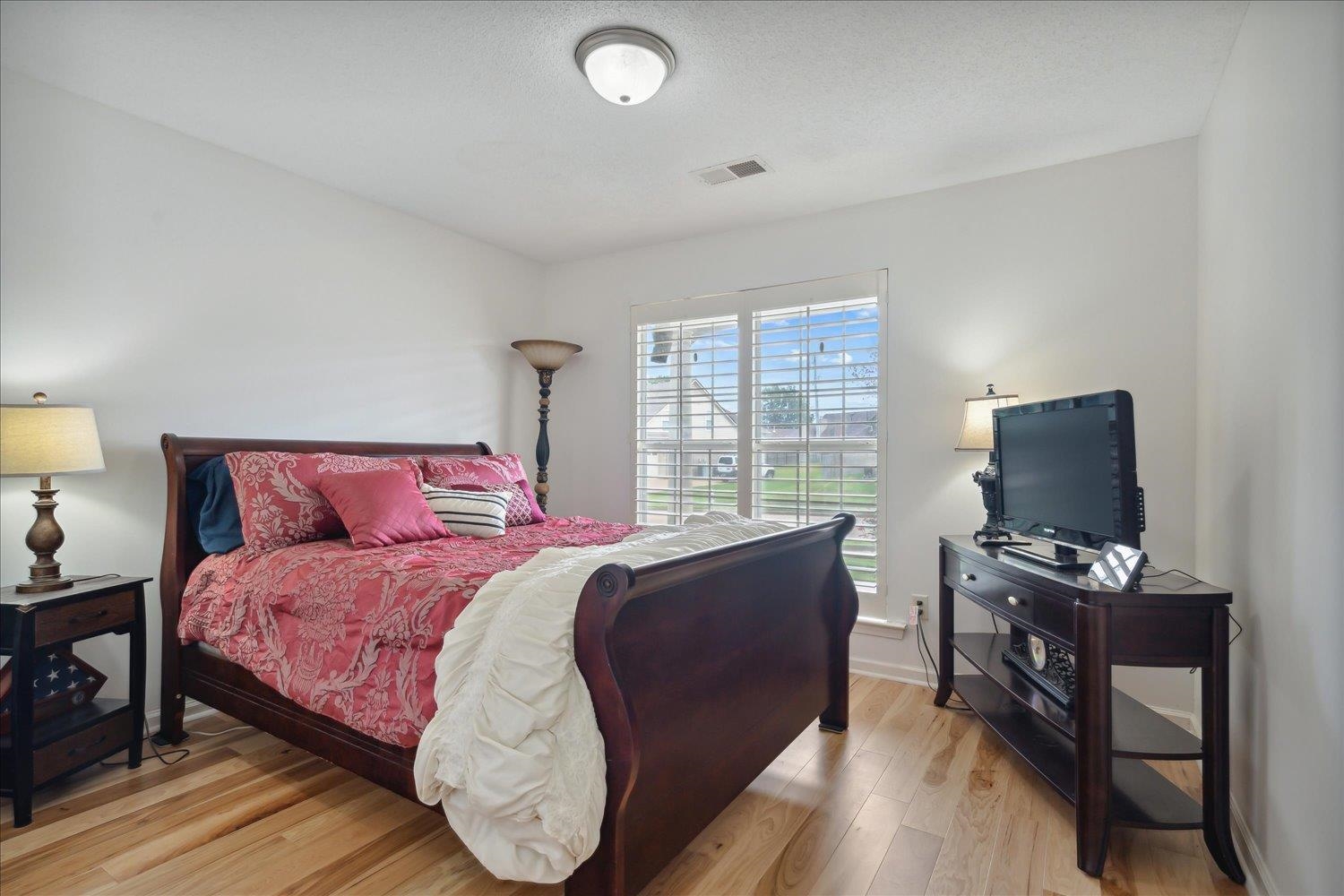 7464 Britt Way Memphis, TN 38125 - Photo 21 of 29 a bedroom with a bed and a flat screen tv