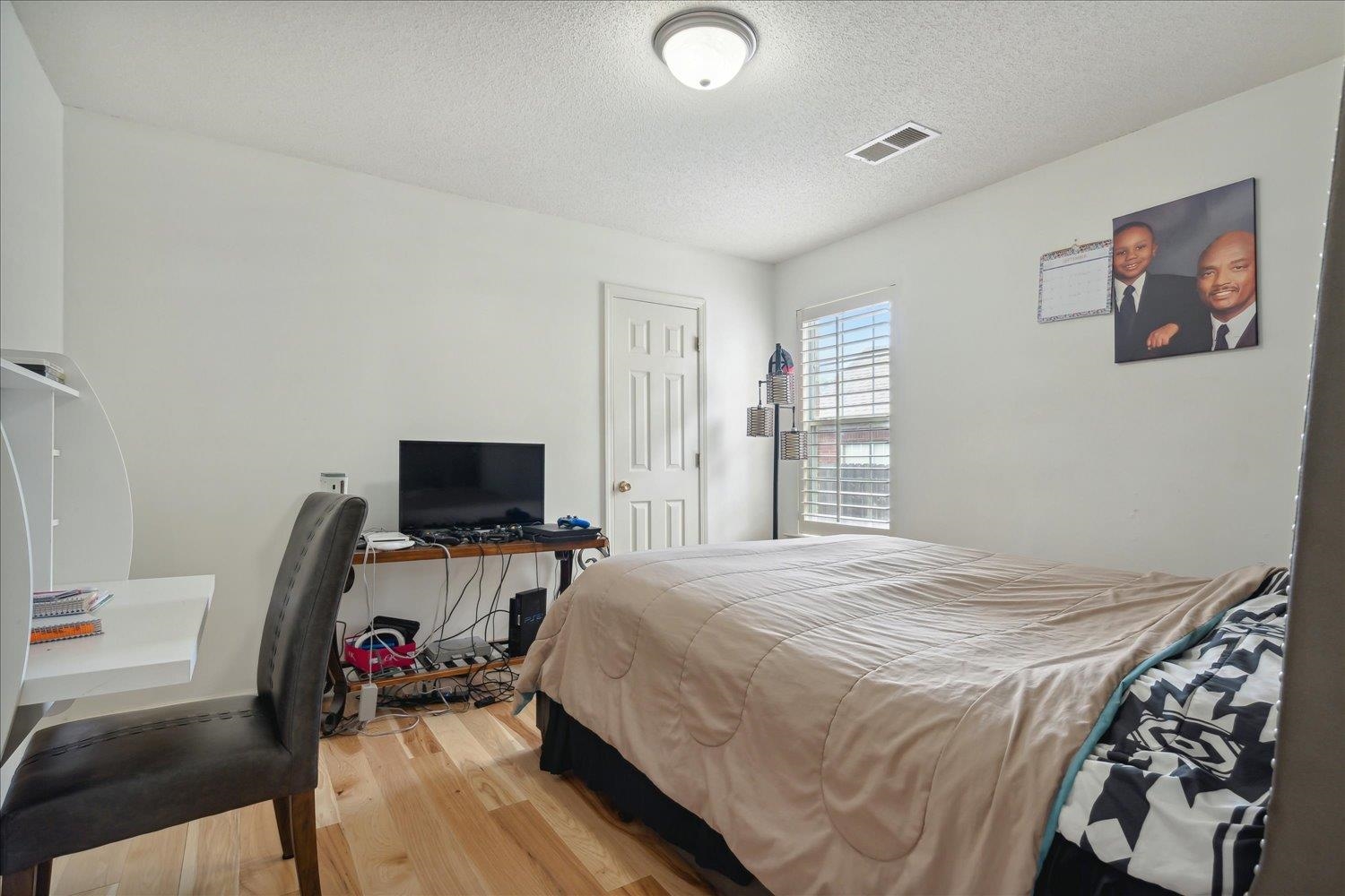 7464 Britt Way Memphis, TN 38125 - Photo 22 of 29 a bedroom with a bed and wooden floor