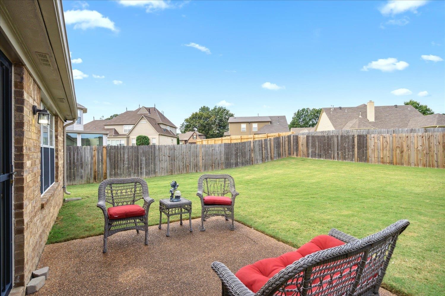 7464 Britt Way Memphis, TN 38125 - Photo 26 of 29 a view of a chairs and table in patio with a yard