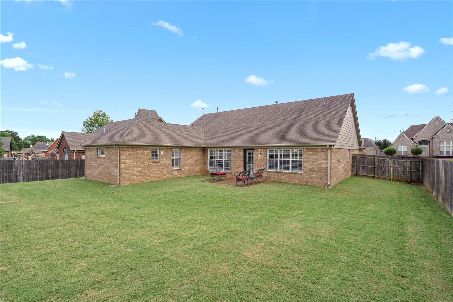7464 Britt Way Memphis, TN 38125 - Photo 29 of 29 a house that is sitting in the grass with large trees